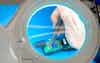 A transducer undergoes repair under a magnifying glass